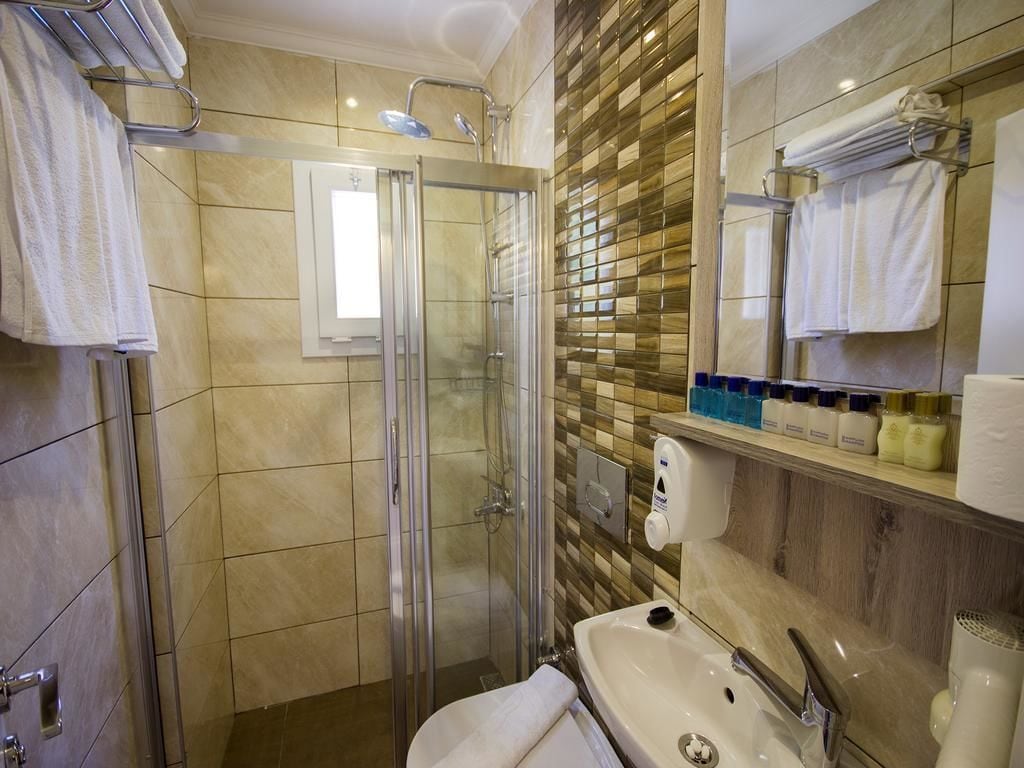 shower, hair dryer, slippers, towels