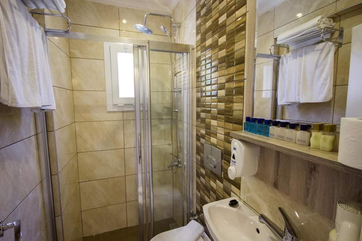 shower, hair dryer, slippers, towels