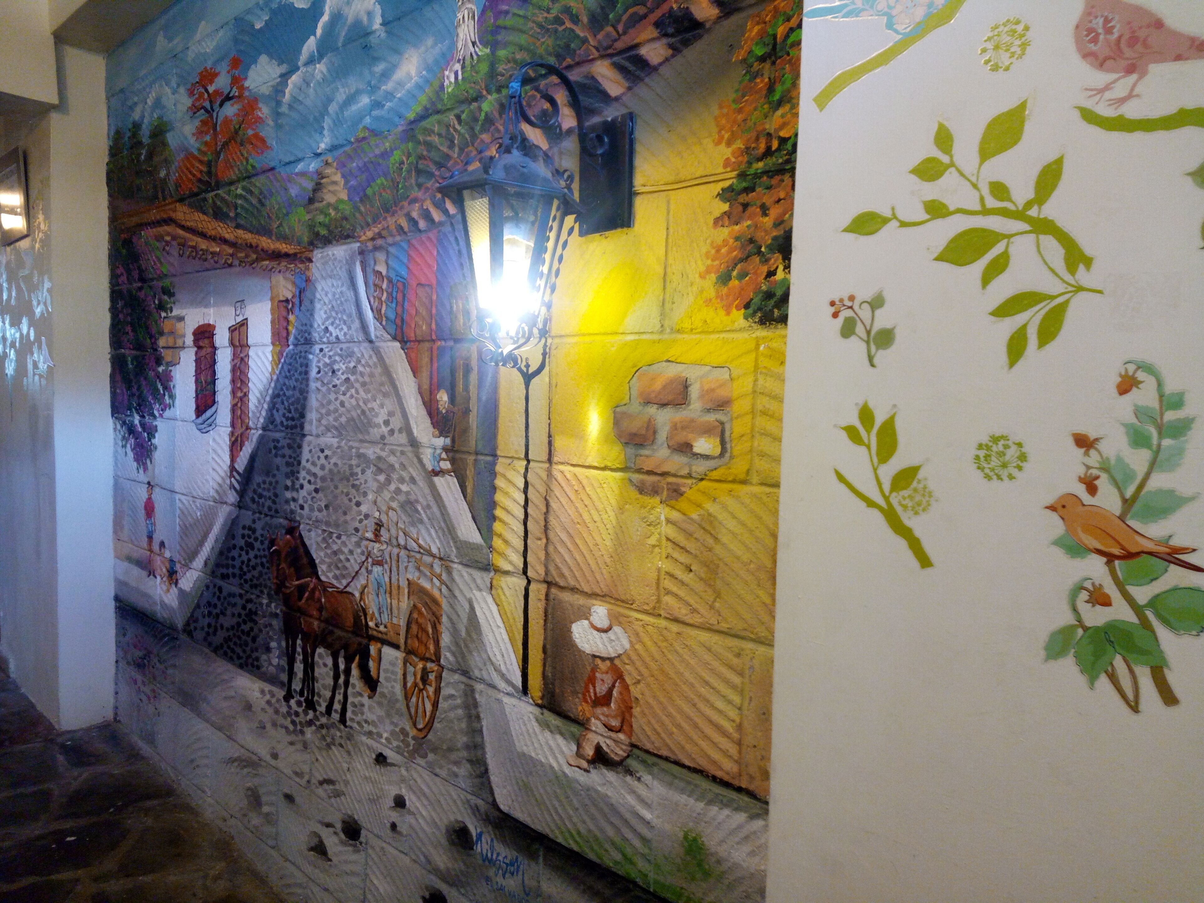 A mural with a horse and cart, a person sitting, and birds.