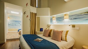 A bedroom with a bed, a painting of the ocean, and a view of the beach. - HOTELO Lyon Charité (Lyon)