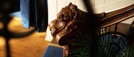 A wooden chair with a carved lion head design.