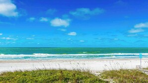 A beach with clear skies and ocean waves.