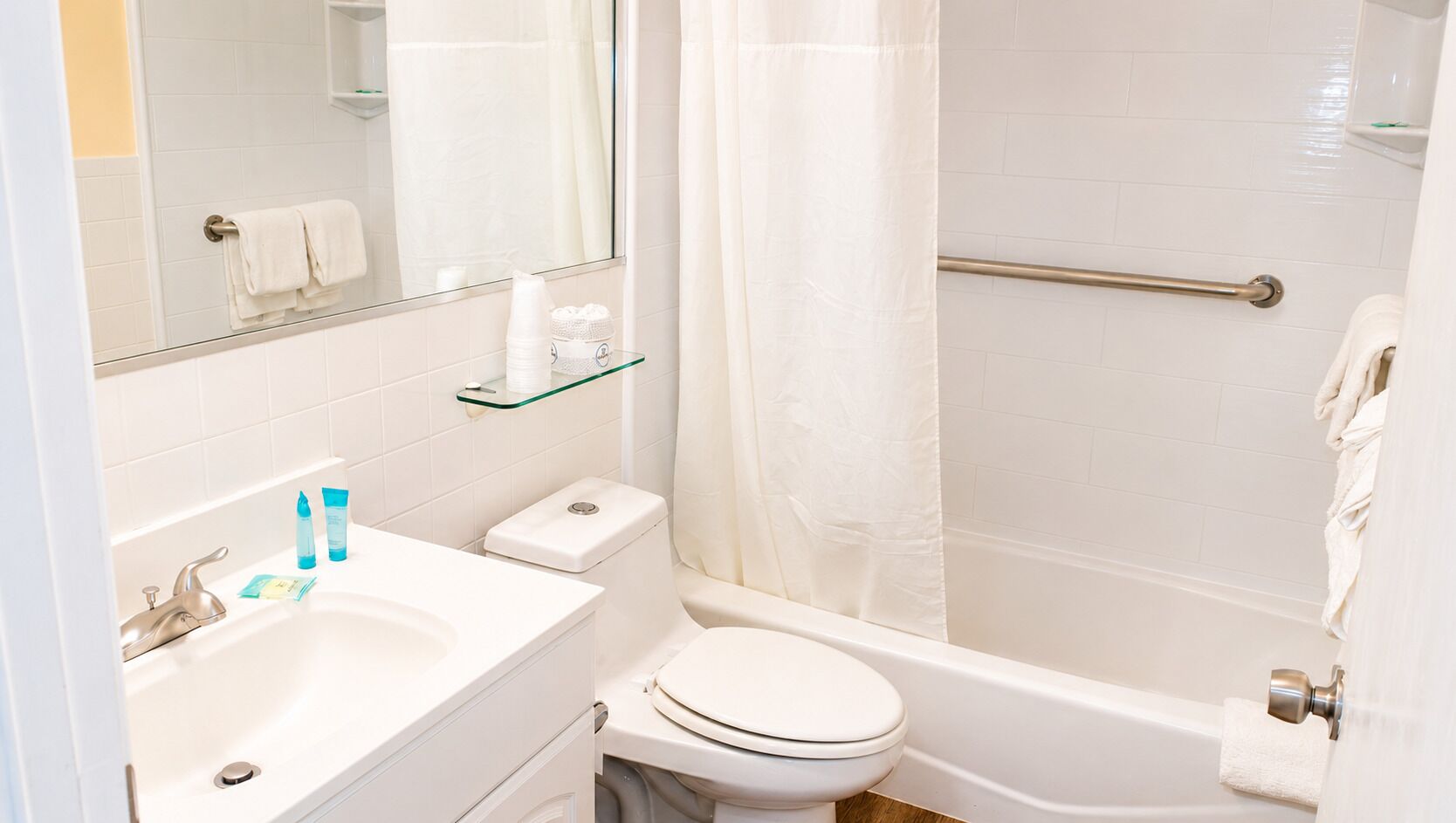 A bathroom with a sink, toilet, and bathtub.