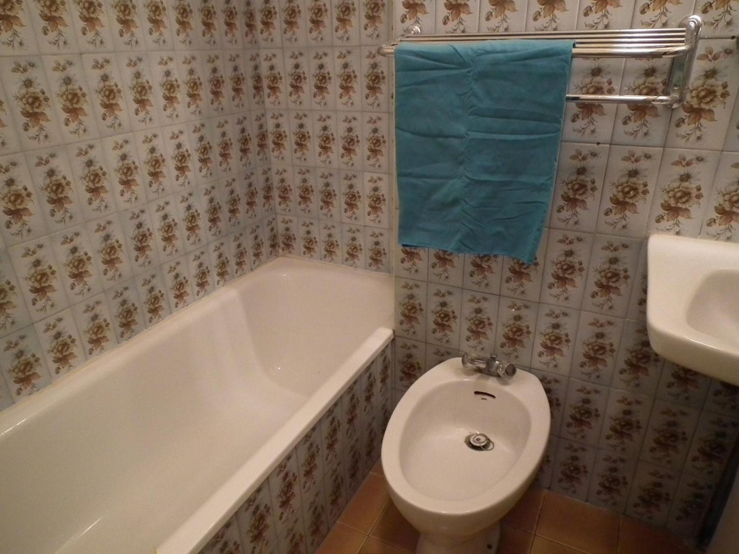 A bathroom with a bathtub, a bidet, and a sink.