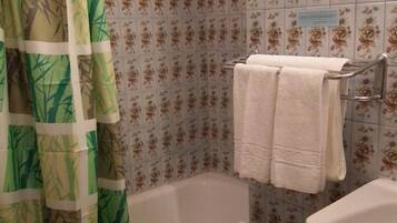 A bathroom with a bathtub, a bidet, and a sink.