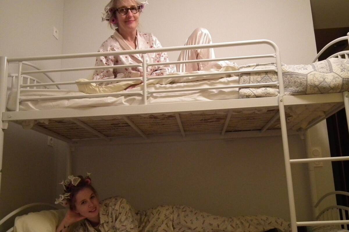 A bunk bed room with two beds, one on top and one below.