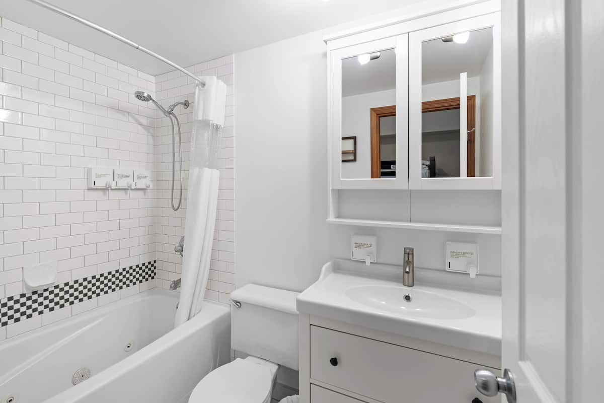 family & work retreat in whistler by mva | bathroom | combined shower/bathtub, eco-friendly toiletries, hair dryer, towels