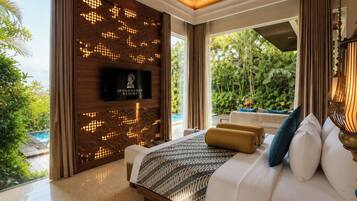 A modern hotel room with a large bed, a television, and a view of a pool and greenery.