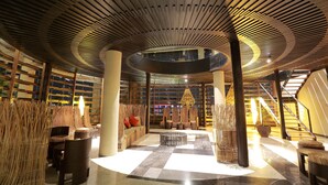 A spacious lobby with a circular skylight, wooden ceiling, and a checkered floor. - The Singhasari Resort (Batu)