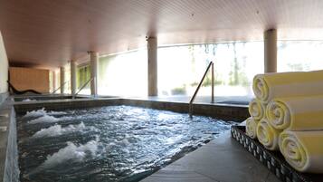 Relax by the pool with a clear view of the water's surface, surrounded by amenities and natural light.