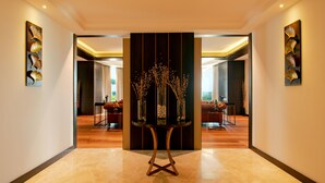A modern hotel lobby with a central decorative table, mirrored walls, and a wooden floor. - Radisson Blu Plaza Hotel Mysore (Mysore)