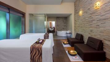 Relax in a stylish room with two single beds, a sofa, and a seating area.