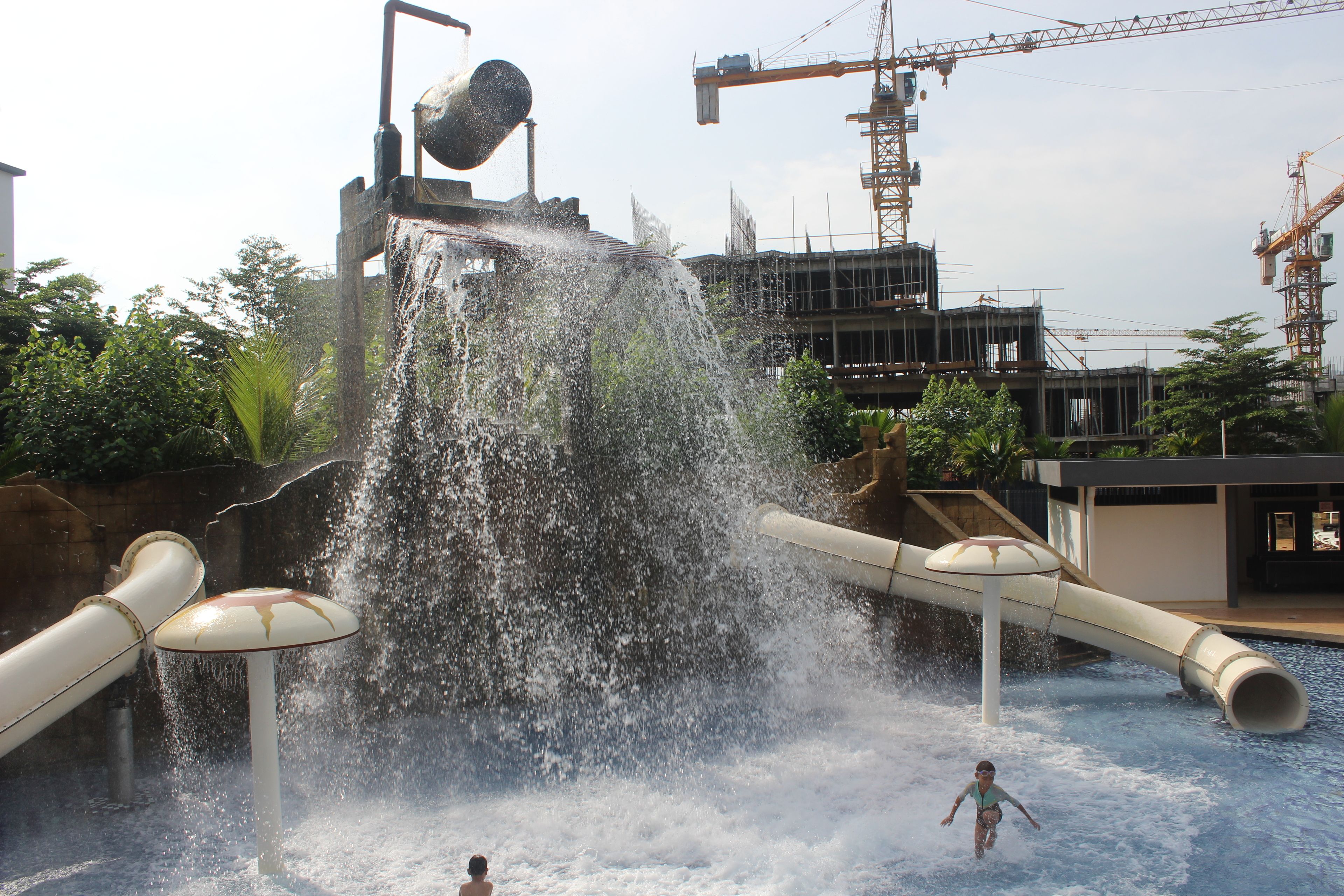 A water park with a large water slide and a pool area.
