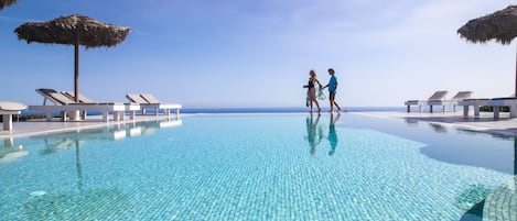 Seasonal outdoor pool, an infinity pool, pool umbrellas, pool loungers