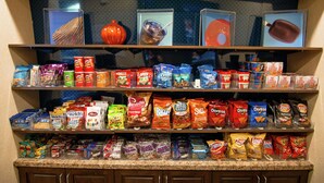 A snack display with various brands and types of chips and snacks. - Hampton Inn & Suites Dallas/Frisco North-FieldhouseUSA (Frisco)
