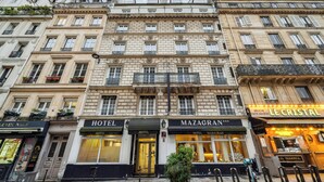 A multi-story hotel with "HOTEL" signage, a "MAZAGRA" restaurant, and a "LE CRISTAL" establishment. - Hôtel Mazagran (Paris)
