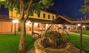Enjoy a serene evening in our beautifully landscaped garden, featuring a tranquil seating area and a charming pergola.