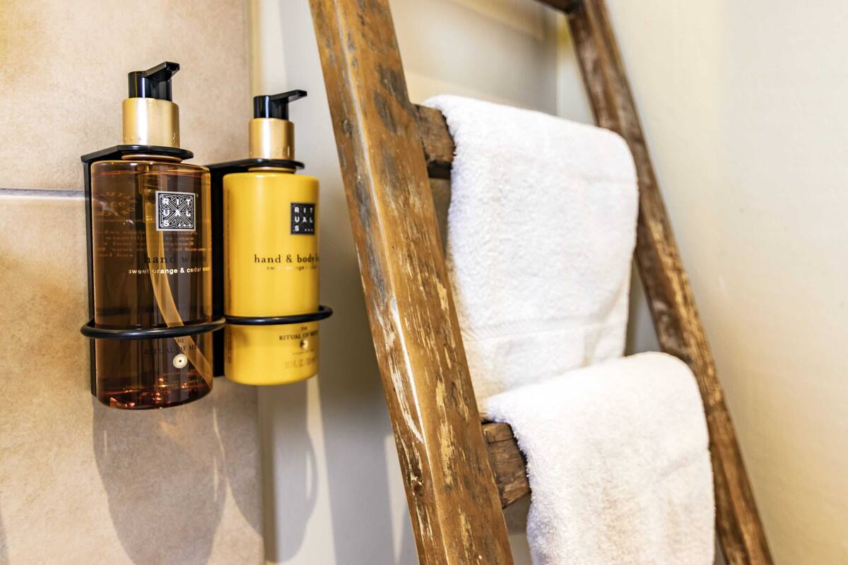 designer toiletries, hair dryer, towels, soap