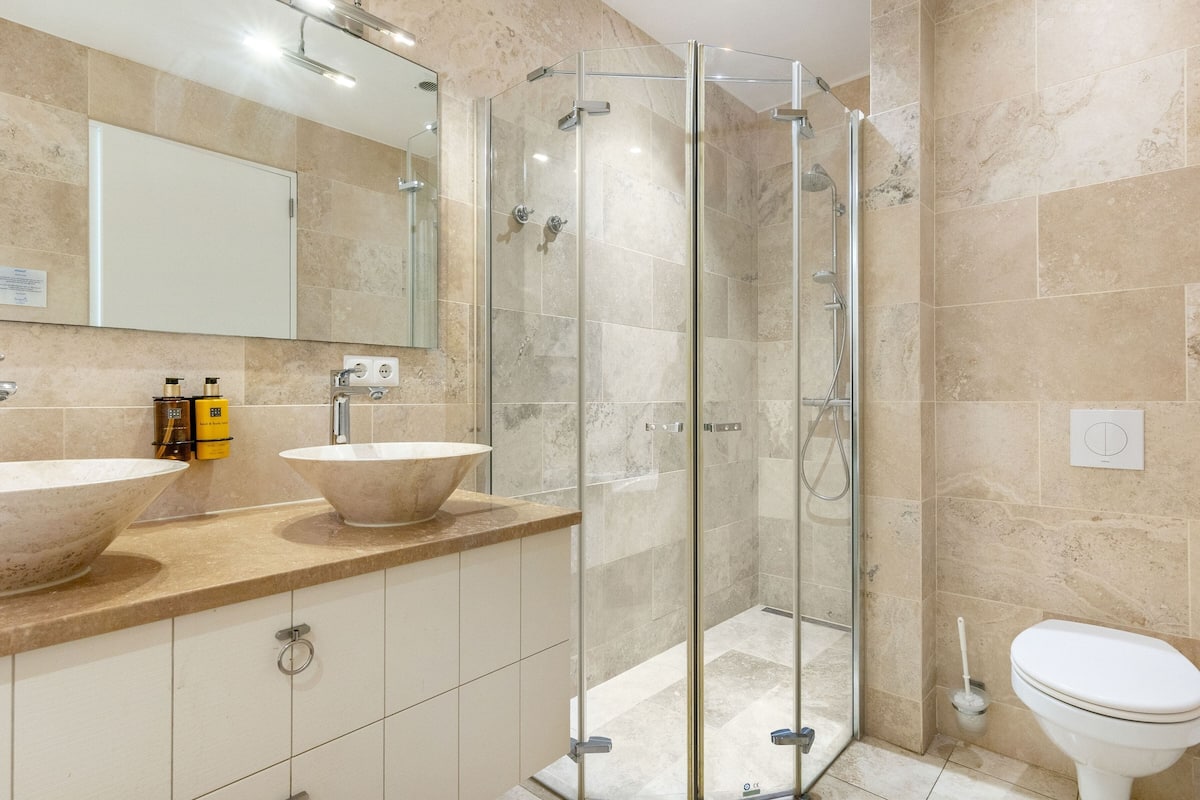 king suite with balcony | bathroom | designer toiletries, hair dryer, towels, soap