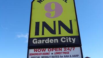 A National Inn sign with amenities like 24/7 availability, remodeled rooms, outdoor pool, and free high-speed internet.