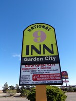 A National Inn sign with amenities like 24/7 availability, remodeled rooms, outdoor pool, and free high-speed internet.