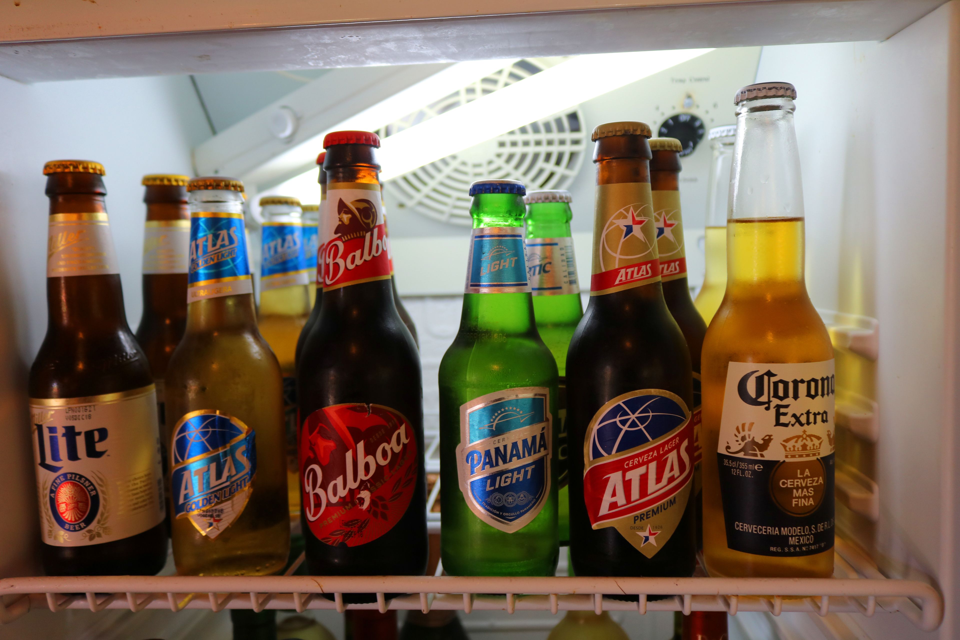 A refrigerator stocked with various beer bottles.