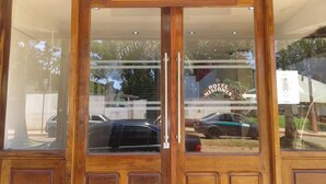 A wooden double door entrance with a sign above reading "HOTEL MISIONES".