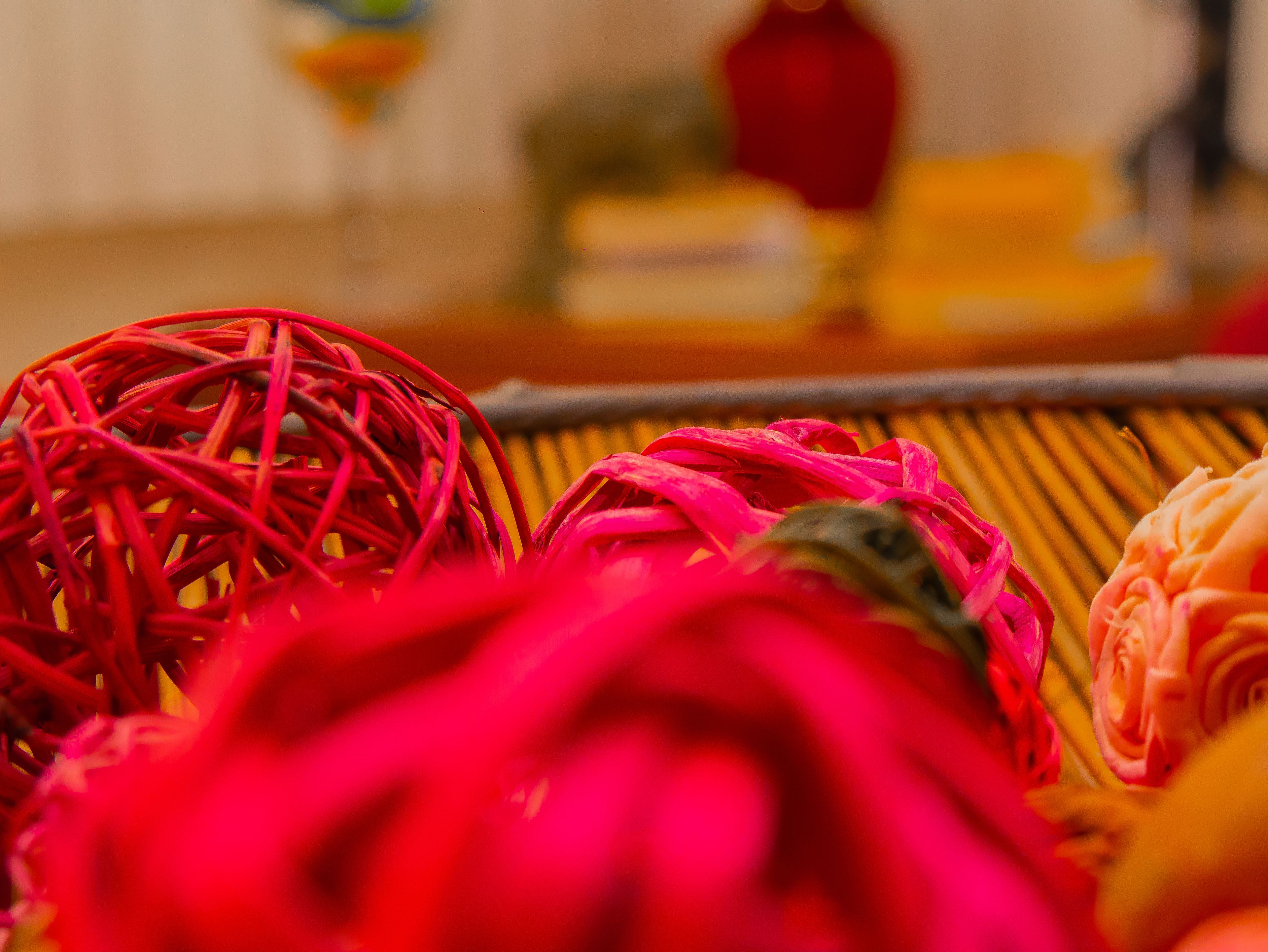 A close-up of colorful, textured objects, possibly decorative items, in a room with a blurred background.