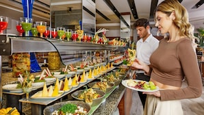 A buffet with various food and drink options, including salads, cheeses, and colorful beverages. - Corendon Grand Park Lara - Ultra All Inclusive (Antalya)
