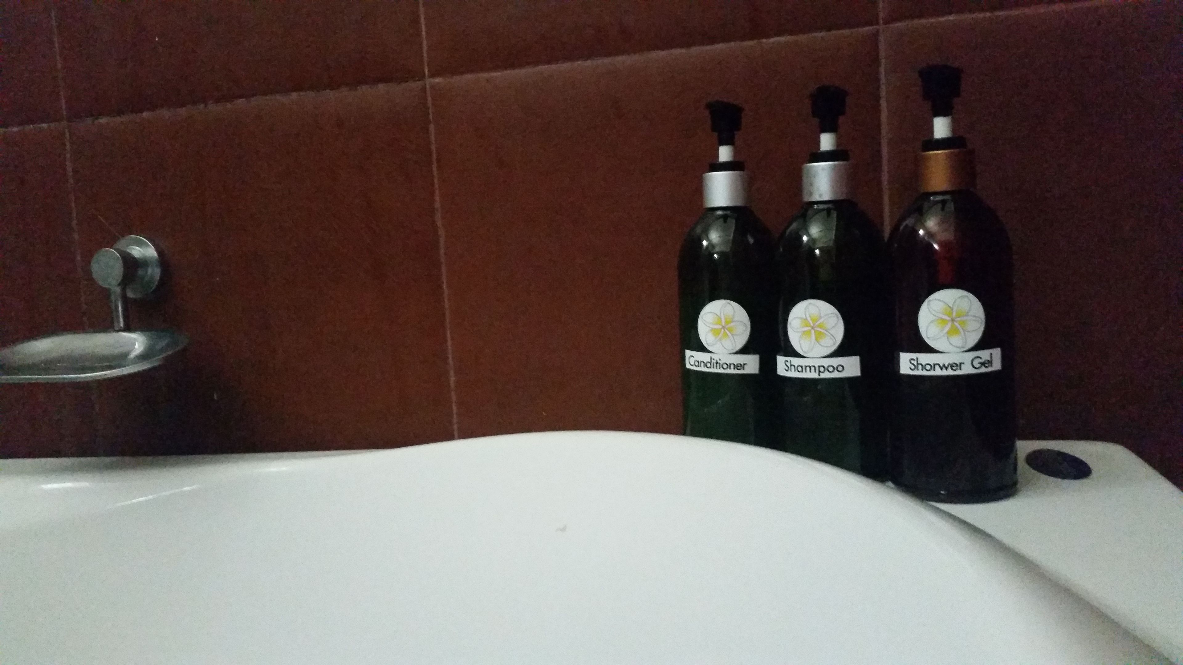 deluxe room | bathroom | rainfall showerhead, hair dryer, bathrobes, towels