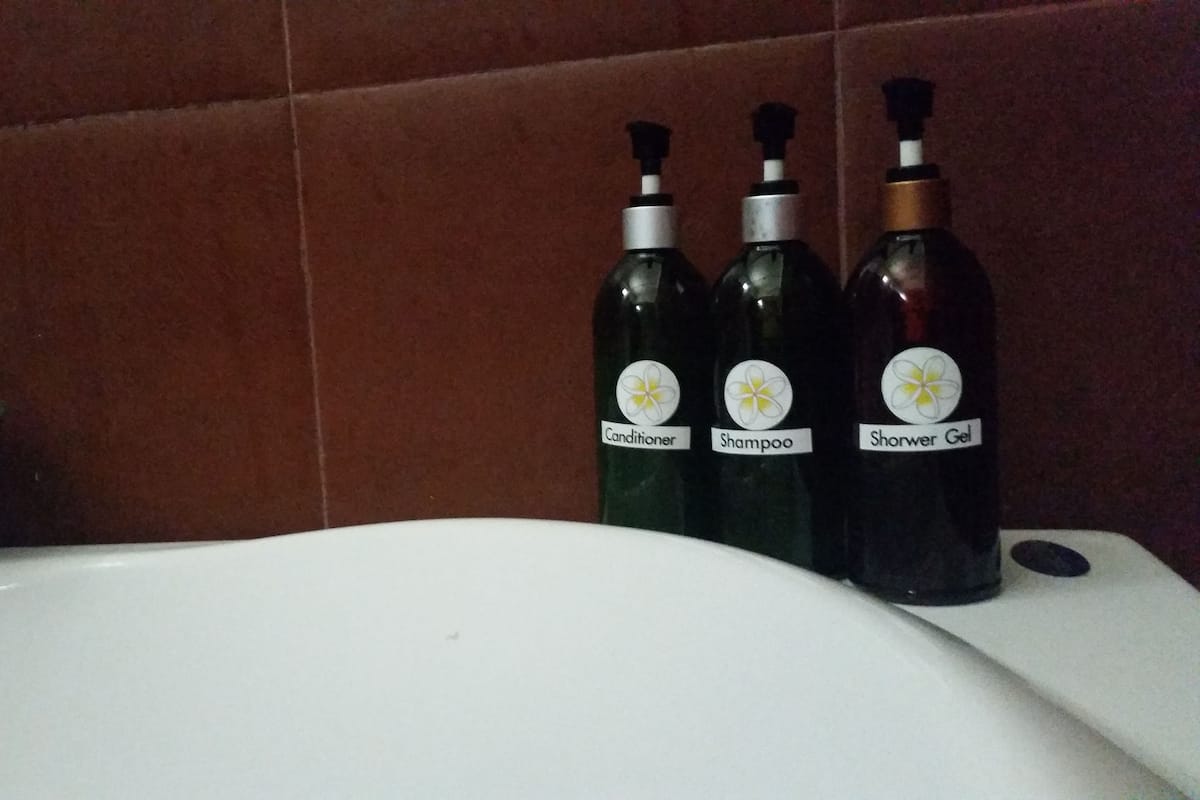 deluxe room | bathroom | rainfall showerhead, hair dryer, bathrobes, towels