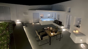 A modern outdoor dining area with a table set for two, a hot tub, and a seating area with a view of the sky. - Anemolia Villa (Santorini)