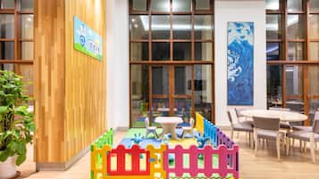 Children can play and explore in this vibrant play area, featuring a play mat and fun structures.