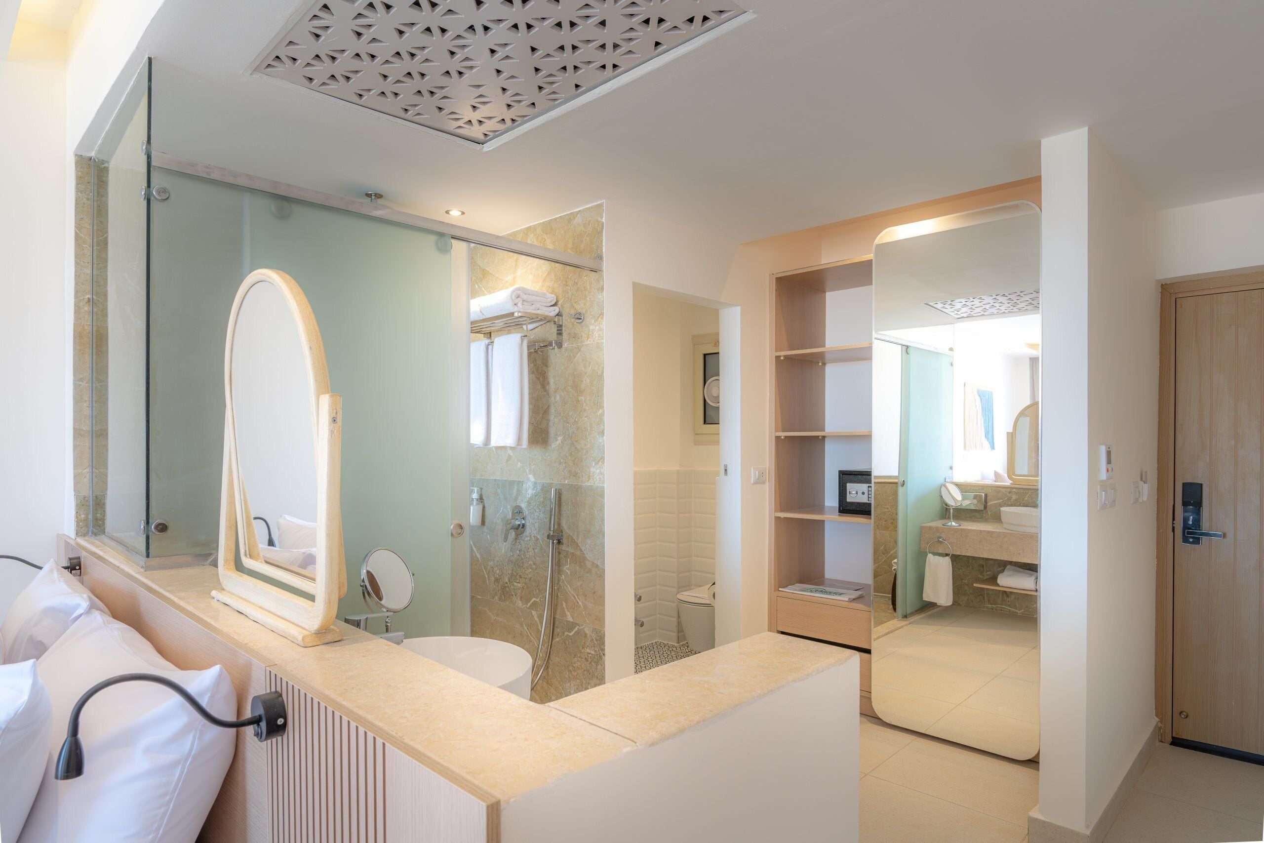 Une salle de bain moderne avec une douche à parois de verre, un grand miroir et un meuble-lavabo.