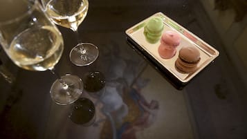 A table with three wine glasses and a tray of macarons.