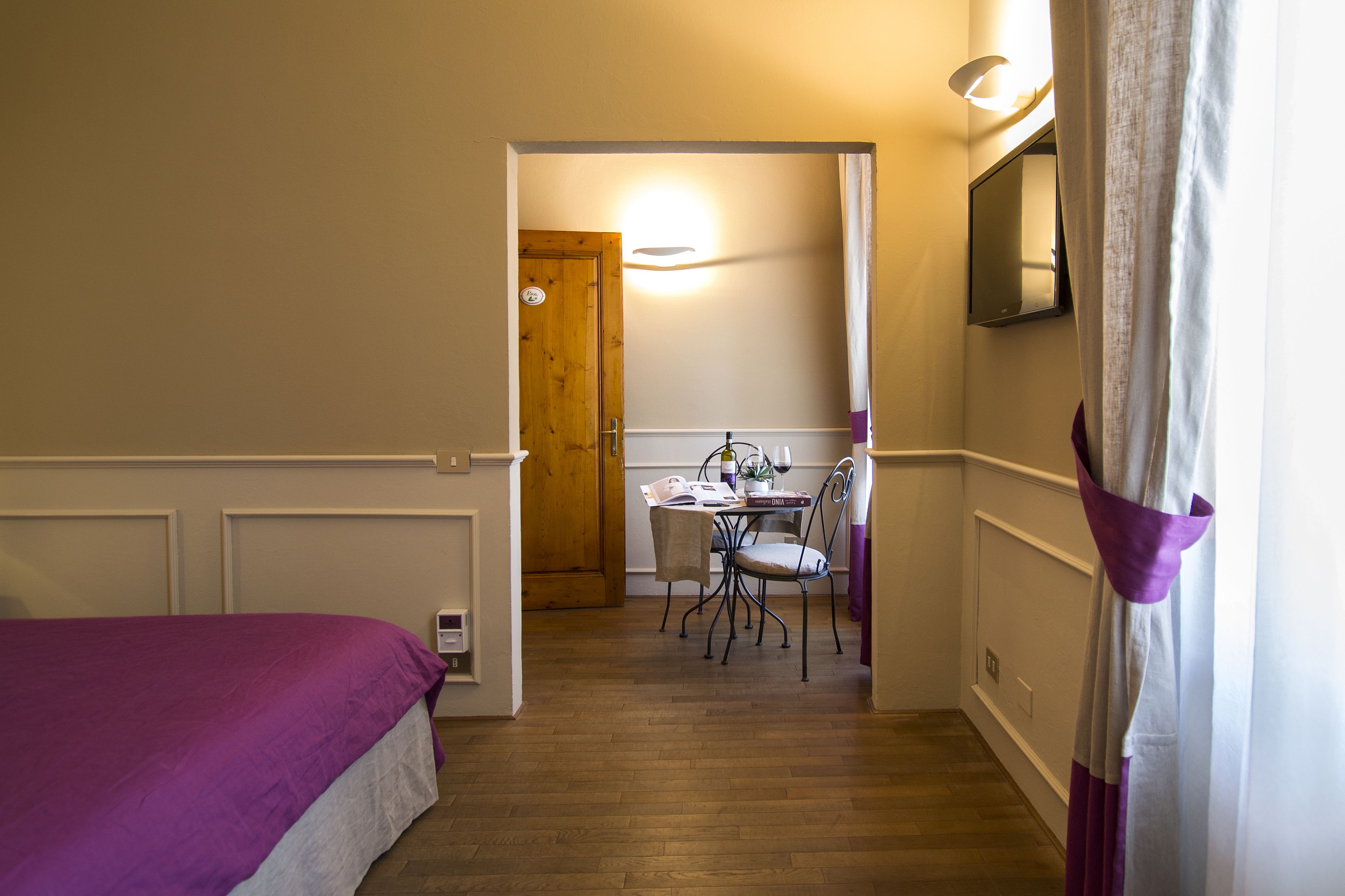 A bedroom with a bed, a desk, and a chair.