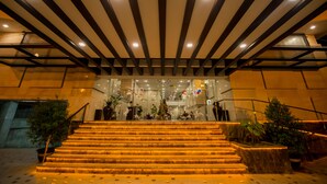 A staircase with illuminated steps leading to a modern building entrance. - Hotel Parami (Yangon)