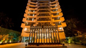 A multi-story hotel with a modern design, featuring a prominent entrance with a star above the name. - Hotel Parami (Yangon)