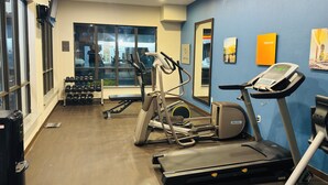 A gym with treadmills, elliptical machines, and dumbbells. - Comfort Suites Plymouth near US-30 (Plymouth)
