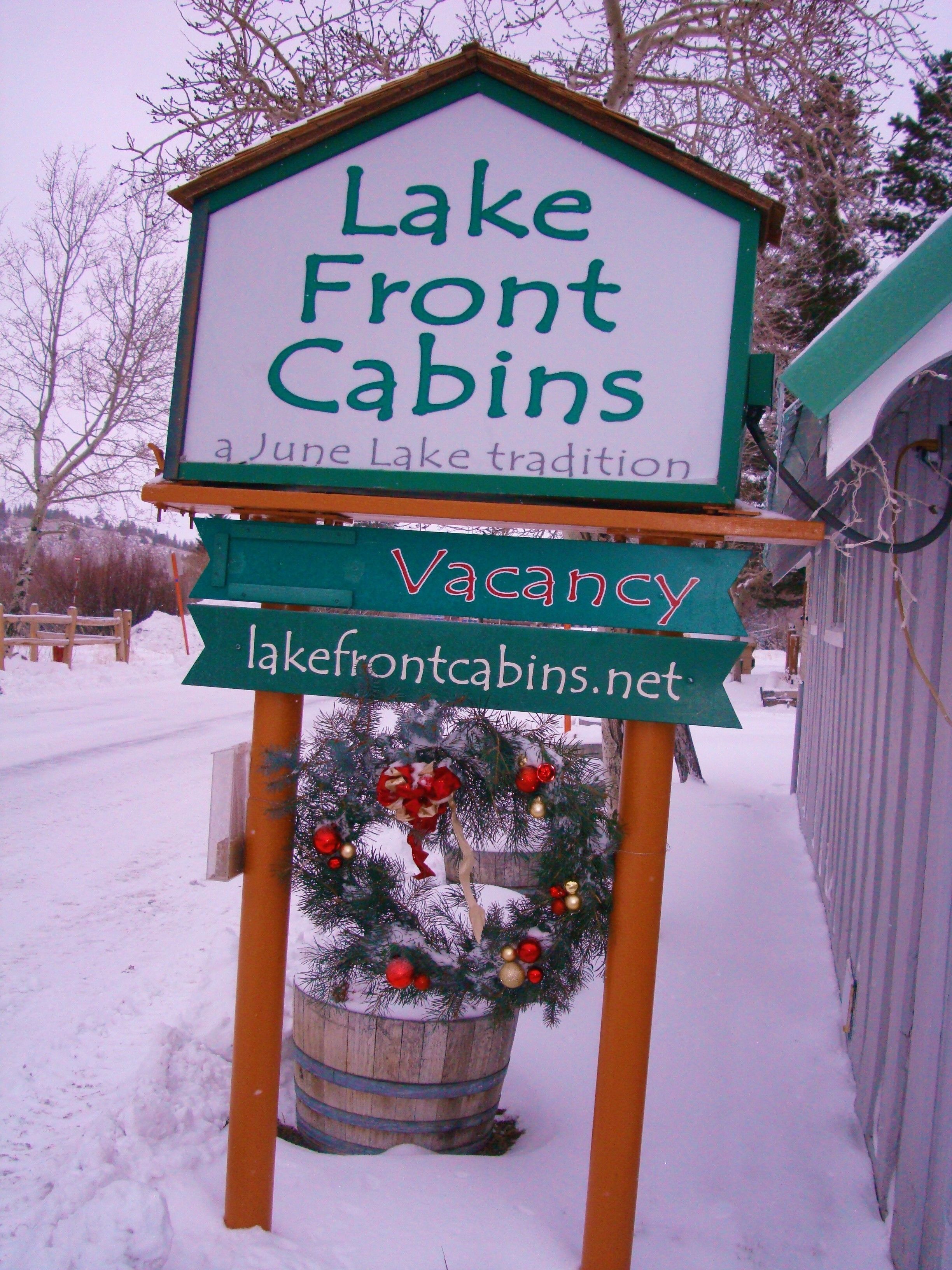 A sign for Lake Front Cabins advertising a June Lake tradition and a vacancy.