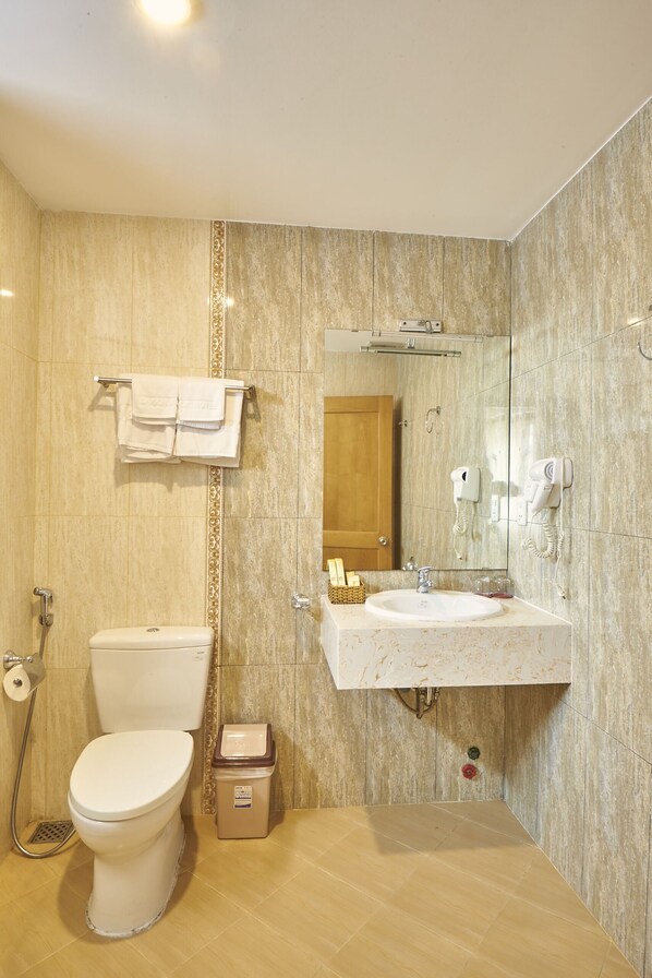 A bathroom with a toilet, sink, and shower. - Sai Gon's Book Hotel - The Airport Front (Ho Chi Minh City)