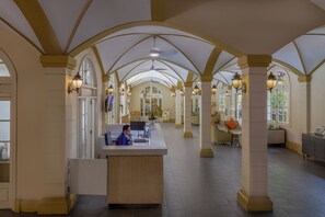 A spacious lobby with high ceilings, arched columns, and a reception desk. - Central Mansions Hotel and Apartments (Phnom Penh)
