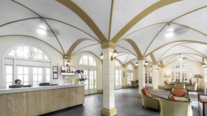 A spacious lobby with a reception desk, comfortable seating areas, and large arched windows. - Central Mansions Hotel and Apartments (Phnom Penh)