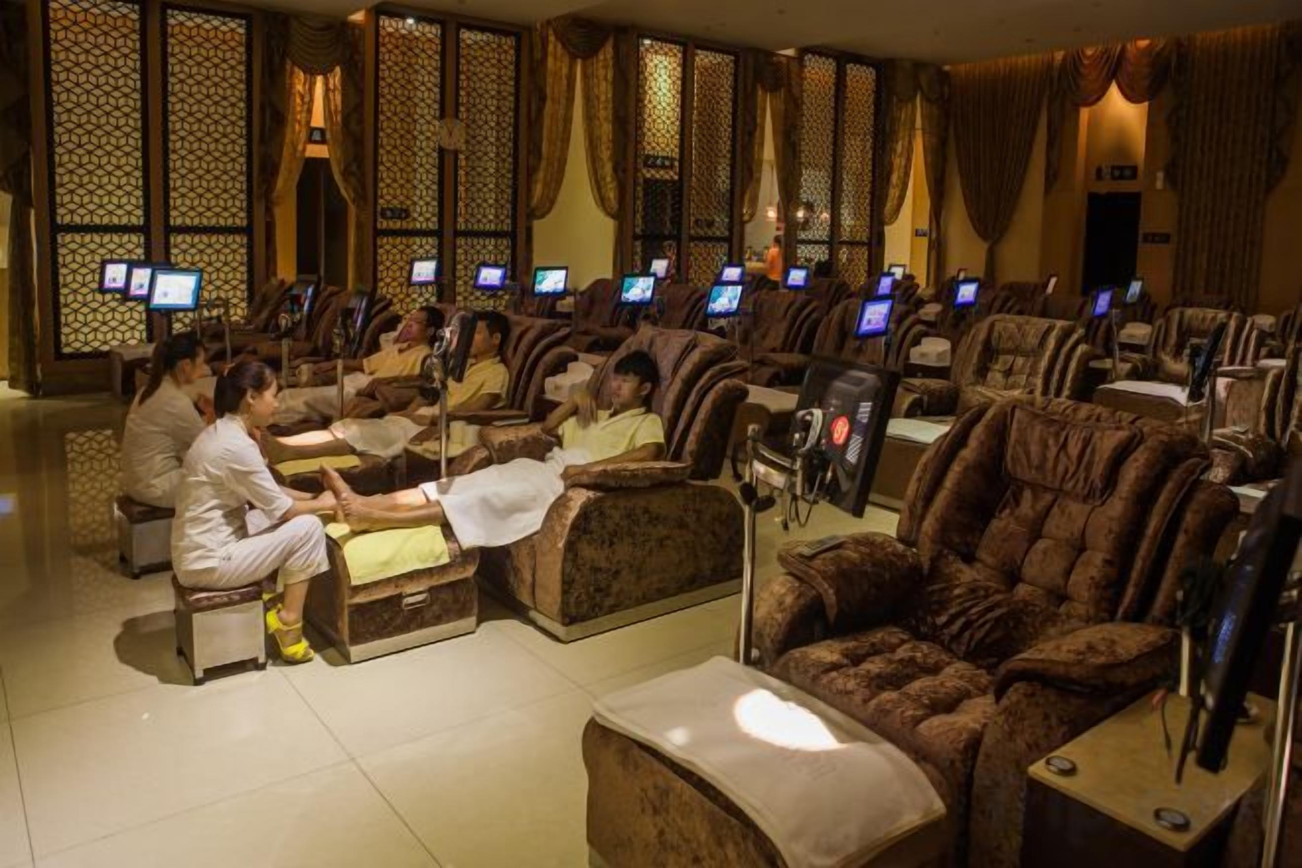 A massage parlor with multiple massage chairs and individual treatment areas.