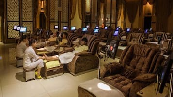 A massage parlor with multiple massage chairs and individual treatment areas.