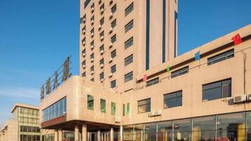A multi-story hotel with a modern facade, large windows, and a prominent entrance.