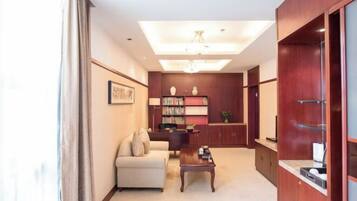 A modern living room with a sofa, coffee table, and a bookshelf.