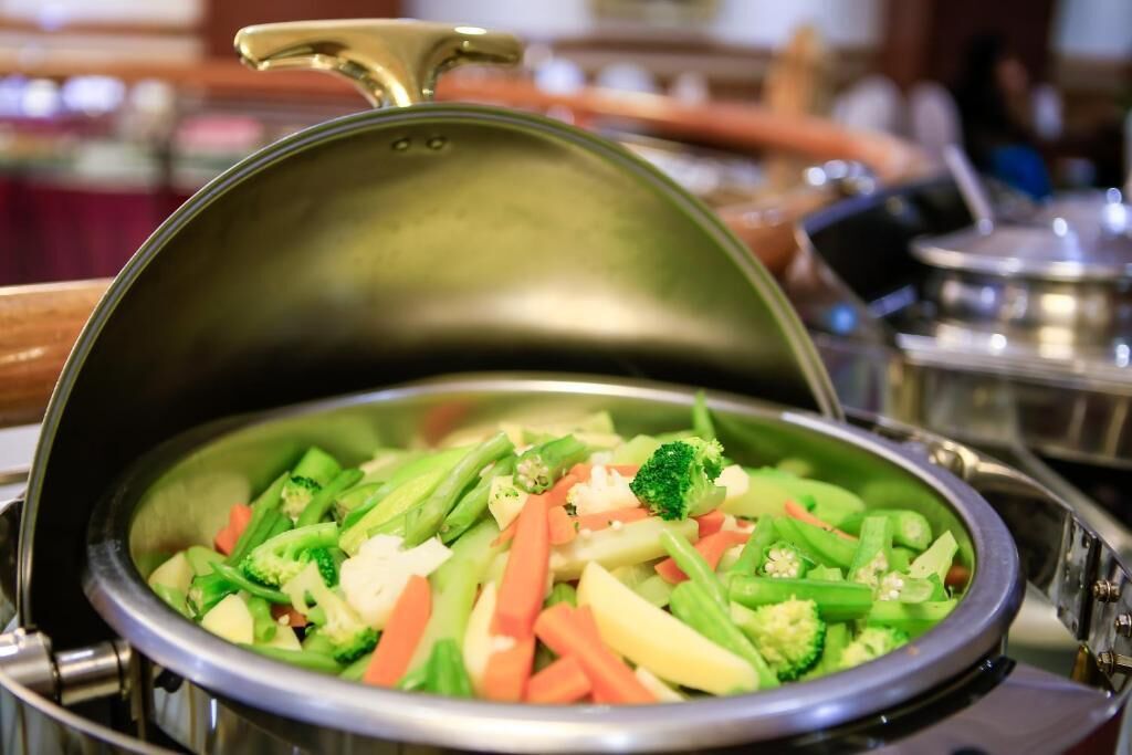 A covered dish with various vegetables.