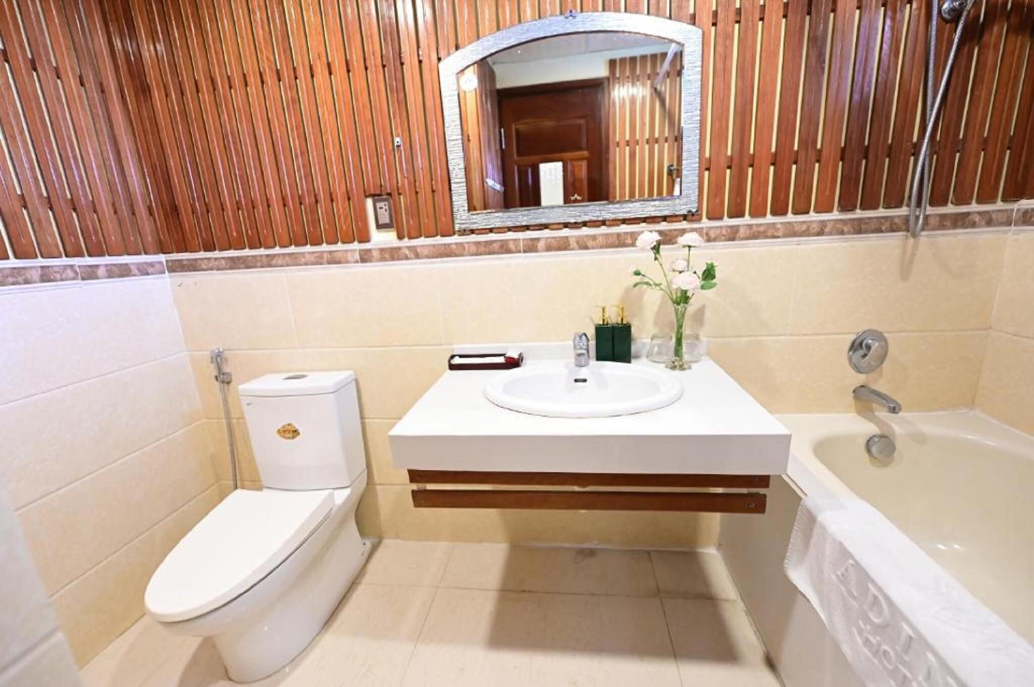 A bathroom with a toilet, sink, and bathtub.