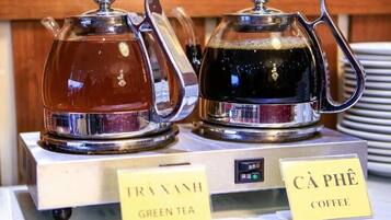 Two glass carafes labeled "Green Tea" and "Coffee" on a display stand.